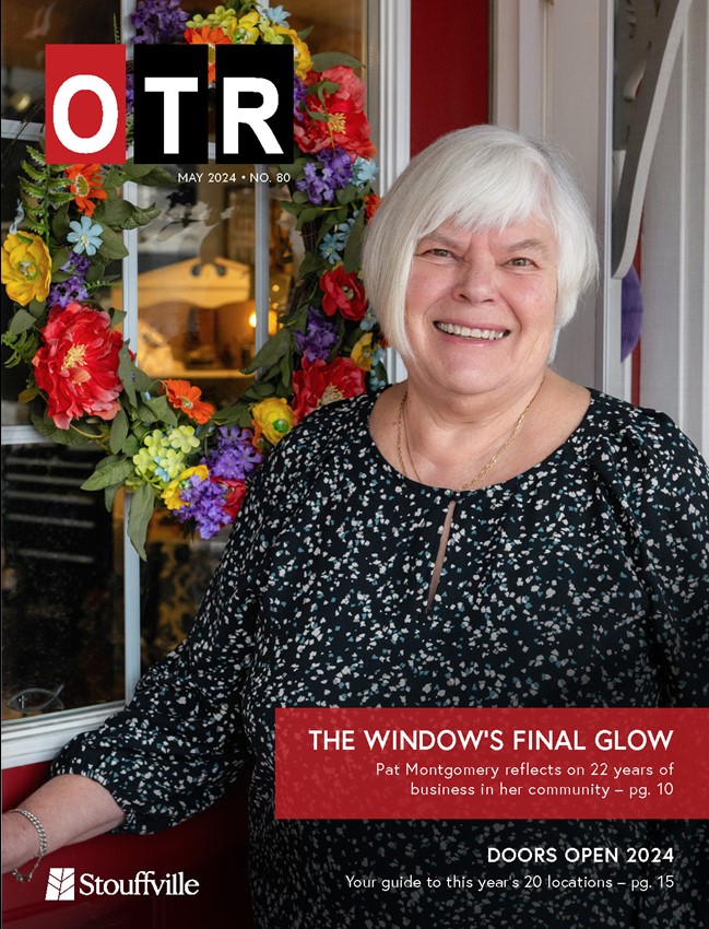 cover of On the Road magazine with woman in front of red door